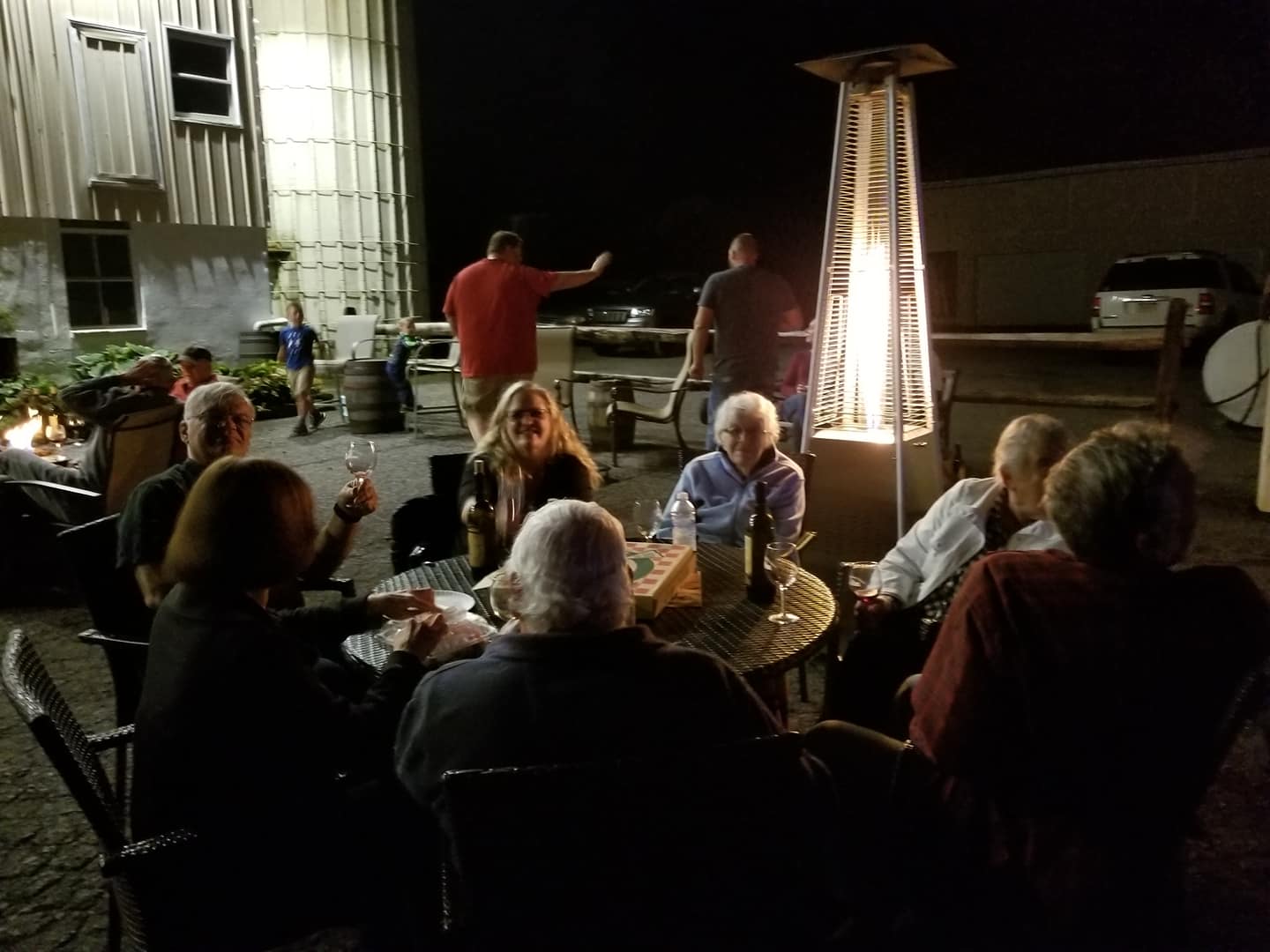 night gathering of people with fire tower